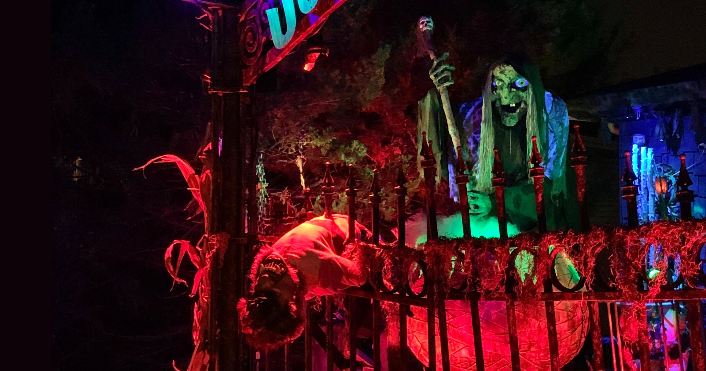 Halloween-themed decorations with a giant witch stirring a cauldron.